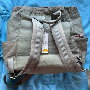 Small light olive green backpack with peach/pink ropes and chains. New with tags